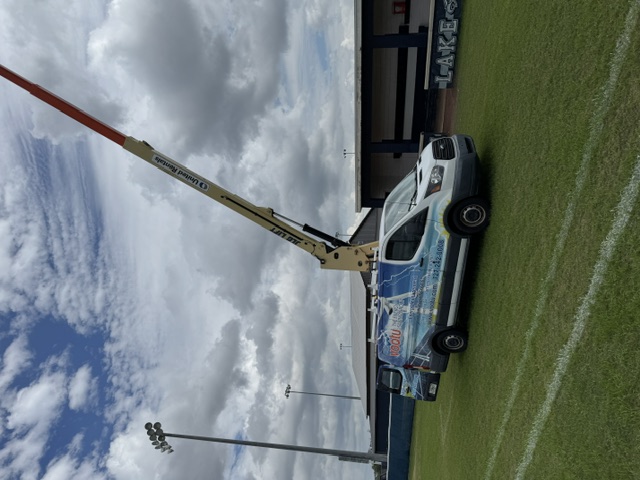 Vootu service vehicle and aerial lift during baseball field lighting work at South Lake High School